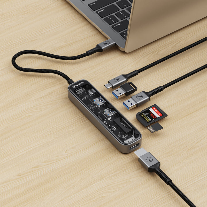 USB hub connected to a laptop on a wooden surface